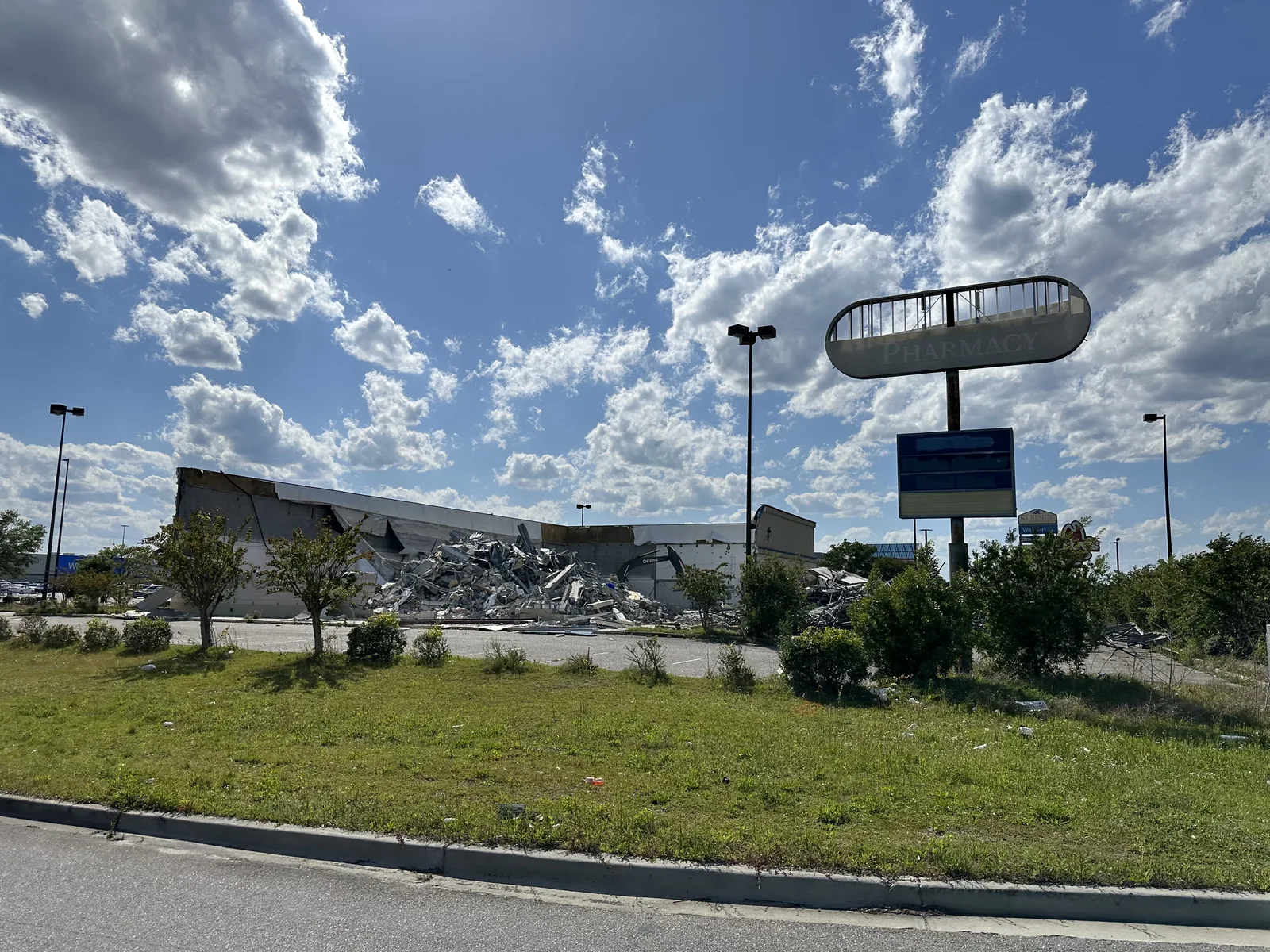 Commercial building demolition with debris staged on site