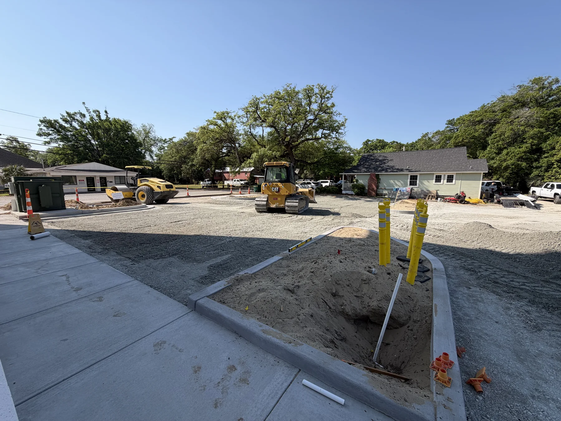 New concrete curb installed around a prepared parking area